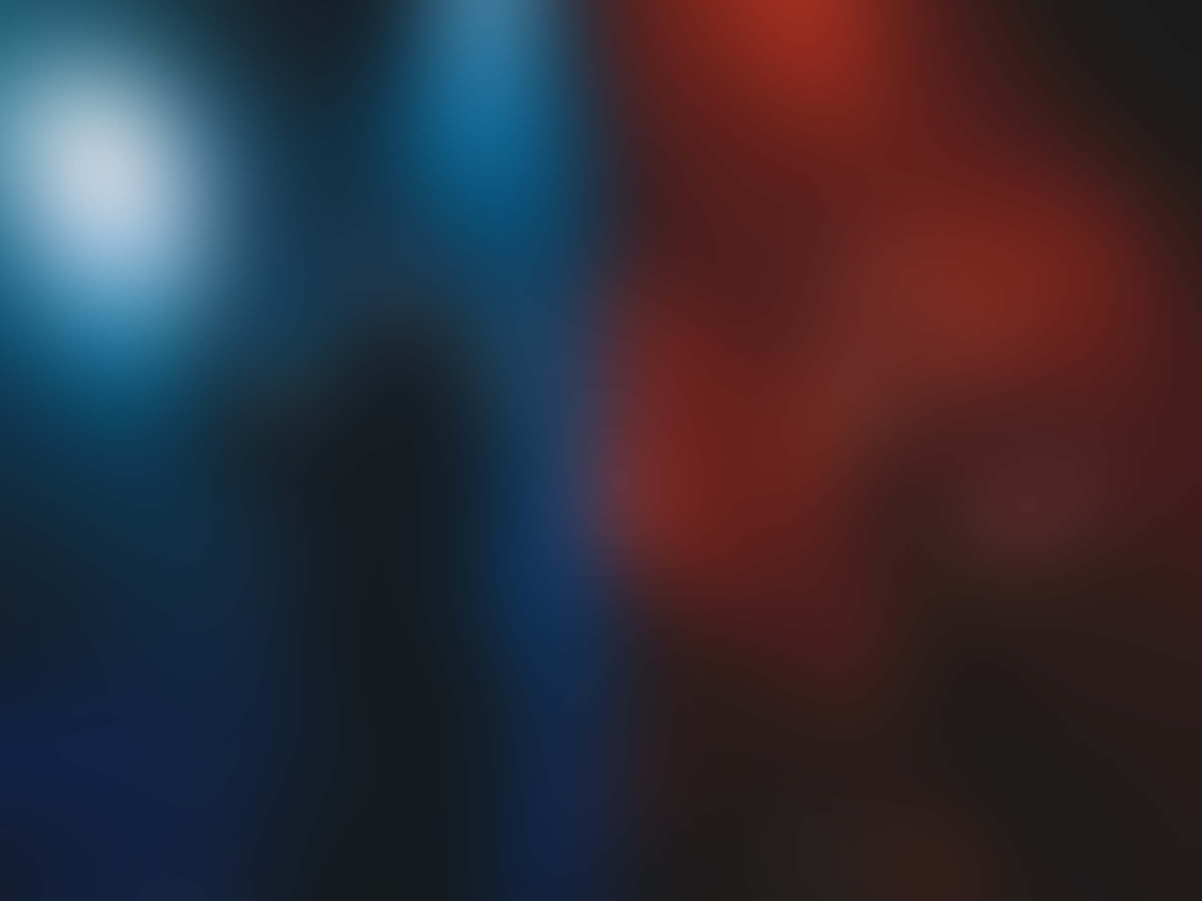 slenderbodies singer max singing, backlit by orange, magenta, and blue stage lights
