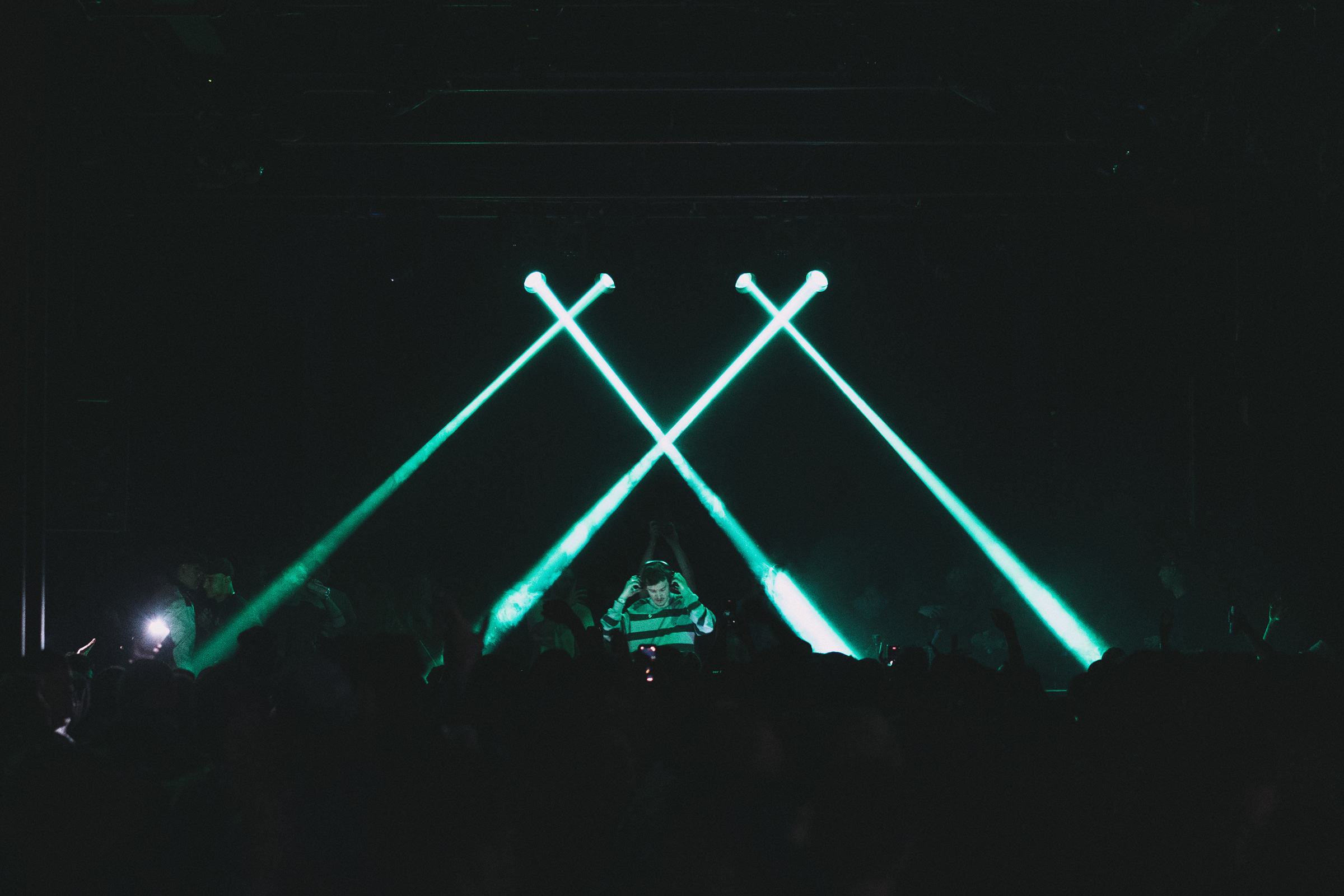 eden and drummer backlit by a single blue light